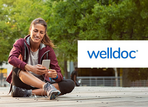 Woman on phone with Welldoc logo
