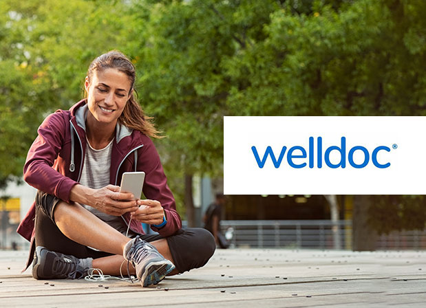 Woman on phone with Welldoc logo
