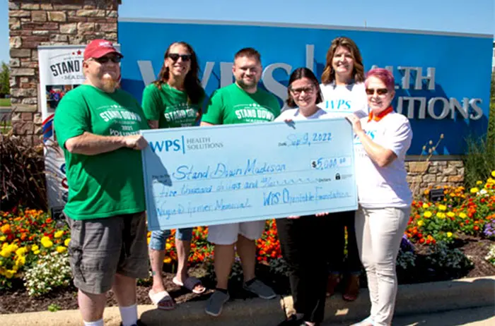 WPS Employees Holding Large Check